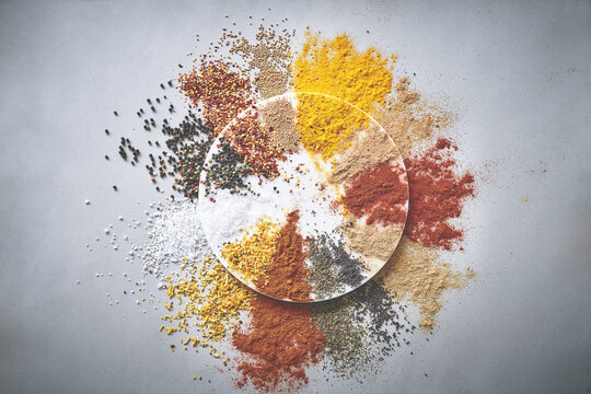 Variety, seasoning and spices in studio for ingredients, powder and culinary aroma on white background. Creativity, condiment and flavor for cooking with herbs, pepper and curry in Indian culture
