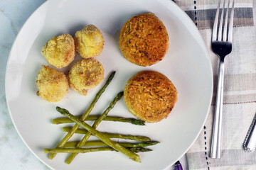 two crab cakes  served with baked scallops