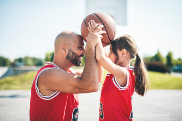 Basketball, sport with a dad and daughter training on a court outside for leisure fitness and fun
