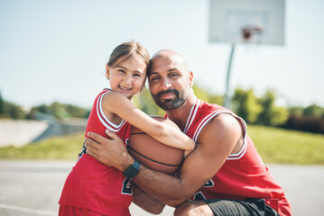 Basketball, sport with a dad and daughter training on a court outside for leisure fitness and fun