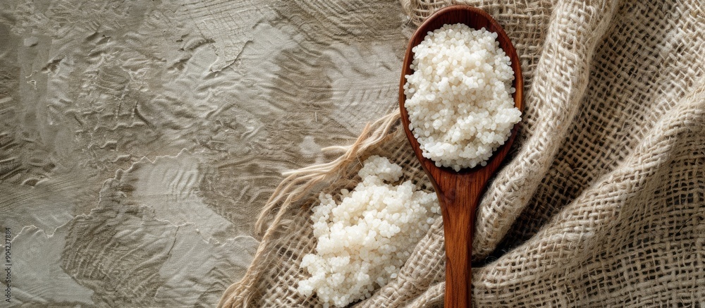 Aufkleber rice and grits displayed on textured fabric with a wooden spoon providing a background for text in t