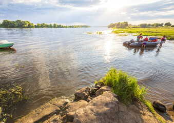 Fototapeta premium A group of people are in a raft on a river