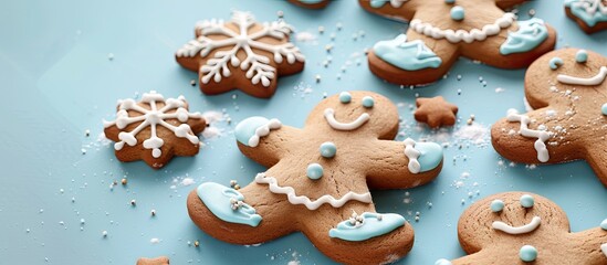 Gingerbread Christmas cookies displayed on a pastel blue backdrop with copy space image