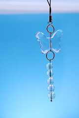 handmade key chain in the form of a butterfly on a blue background