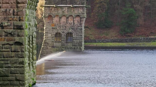Views of the famous Howden and Derwent stone build Dams, used in the filming of the movie Dam Busters. Showing water overflowing over the dam walls with victorian towers on each side of the structure