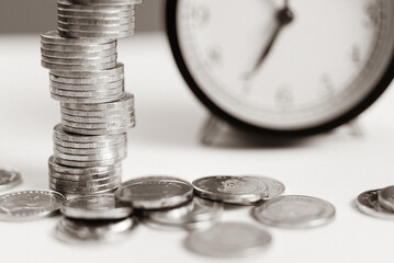 Tax season, Debt collection concept. Coin and alarm clock, white background, time to pay interest....