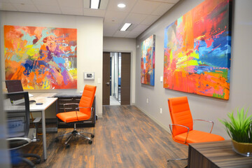 Contemporary office space with medium-density color splashes incorporated into wall art and decor.