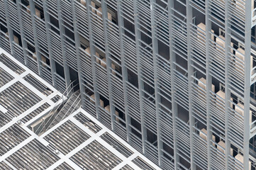 Aerial view of modern building facade showcasing sleek design and architectural features with repeating patterns.