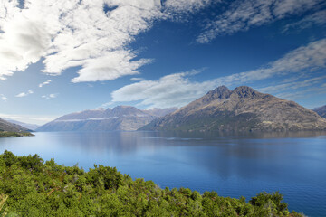 panoramic scenic view of Lake Wakatipu with mountains in the background near Queenstown, South Island, New Zealand