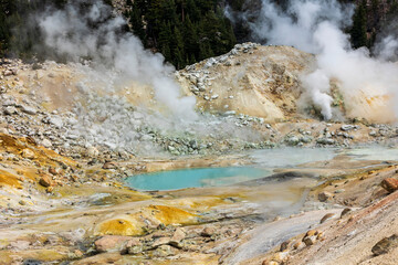 dramatic volcanic landscape of hot steams and sulfur laden pools, hydrothermal area  in Bumpass Hell in Lassen National Park.