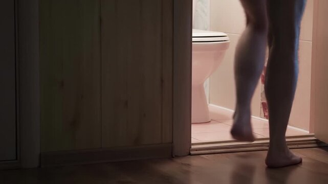А man goes to the bathroom at night. Men's health concept. People wants to pee - urinary incontinence concept