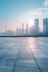 Fototapeta premium A city skyline with a beautiful sunset in the background. The sky is filled with clouds, and the sun is setting, casting a warm glow over the city