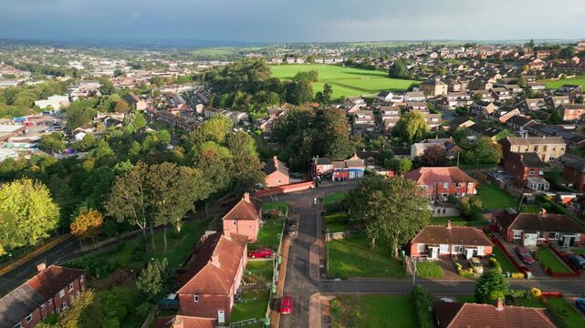 Charming urban living: Red brick council housing in Yorkshire, aerial view, sunny morning, bustling streets.