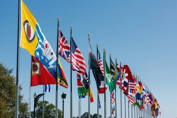 Multiple international flags waving on tall flagpoles against a clear blue sky, representing global unity and diversity.