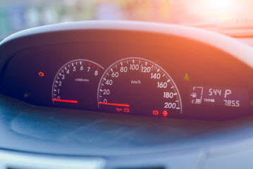 Close-up of a speedometer on a car dashboard showing speed with black and red details
