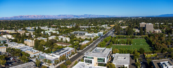 Aerial view of commercial and residential areas of Palo Alto, California toward Mountain View along...