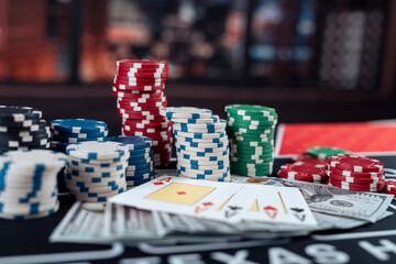 Casino tokens chips, playing card and dollar on table