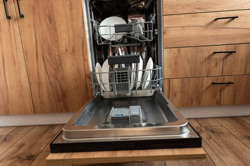 kitchen with built-in open dishwasher with clean dishes