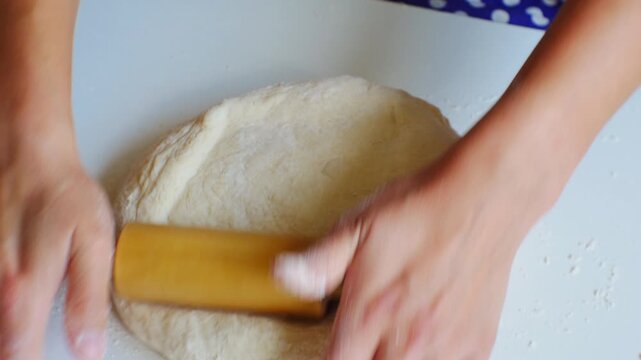 Working with dough with rolling pin. Demonstration of cooking skills at open class. Top close-up view. Cooking school online. Educational courses on cooking in restaurant, cafe or home