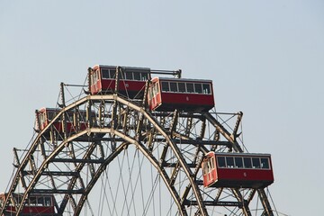 Five red gondolas of the Vienna Giant Ferris Wheel with blue sky
