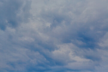 Evening sky draped with blue scalloped clouds