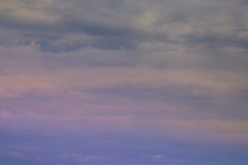 Fototapeta premium Delicate purple sunlight on clouds in blue sky