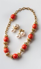 Elegant necklace and earrings set with pearls and red beads