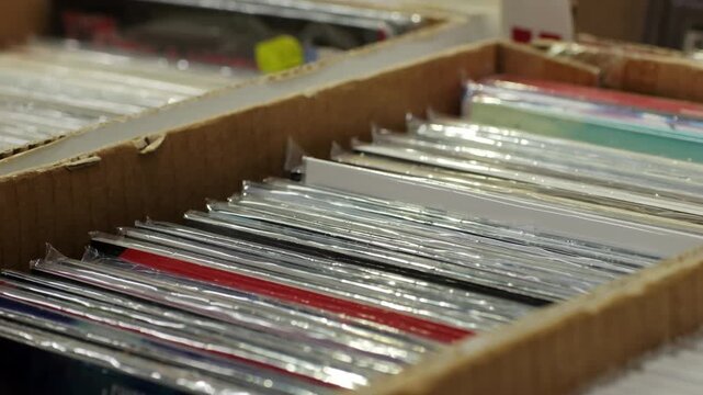 Comic books are kept in protective sleeves inside a cardboard box for preservation and protection