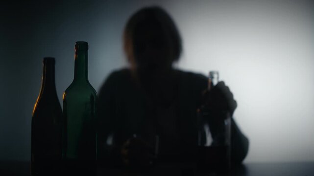 Upset woman drinking alcohol from bottle, feeling lonelily and depressed