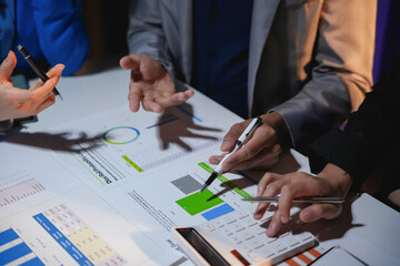 Business team working together on analyzing financial figures on a desk in a meeting