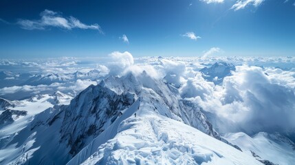 Breathtaking summit view of majestic snow-capped mountains under clear blue sky