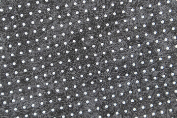 The surface is covered in a mixture of white and black polka dots, an abstract background, and interior decor elements.