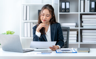 Fototapeta premium Business woman working at desk using laptop Smile and be happy and stay focused.
