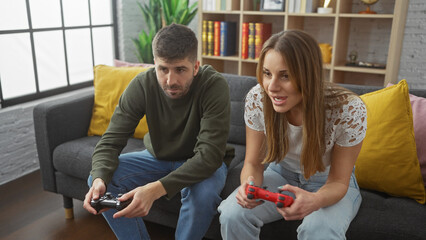 A man and woman sitting on a couch in a cozy living room playing video games together, engrossed...