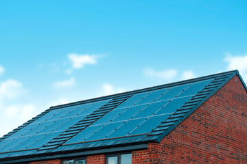 Fototapeta premium Solar Panels Installed on Residential Rooftop in Bright Blue Sky During Daytime