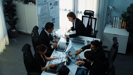 Top view of smart businesspeople working together at meeting. Manager looking at financial document while making decision to invest in stock market. Business people analyze business data. Directorate.