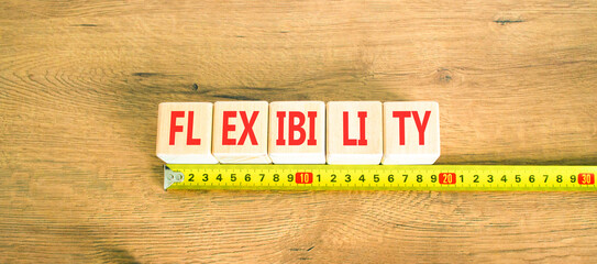 Flexibility symbol. Concept word Flexibility on beautiful wooden cubes. Beautiful wooden background. Beautiful yellow ruler. Business flexibility concept. Copy space.