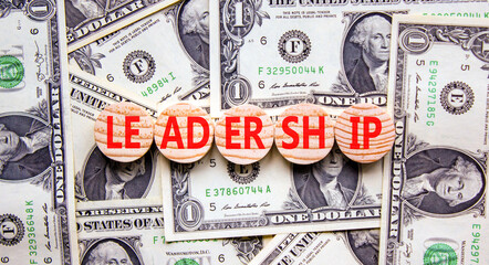 Leadership symbol. Concept word Leadership on beautiful wooden circles. Dollar bills. Beautiful...