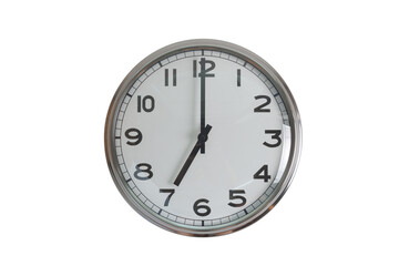 A white round shape wall clock with black hands showing the time of 7 o'clock cutout from background. Short hand at 7 o'clock and long hand at number 12.