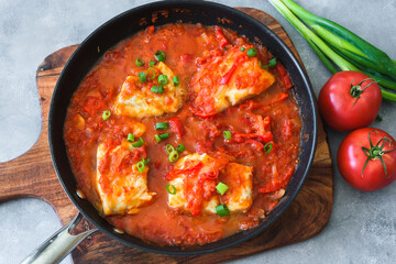 Baked cod fish in tomato and pepper sauce