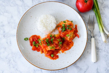 Baked cod fish in tomato and pepper sauce