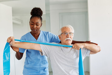 therapist senior man exercise exercising patient physical woman girl therapy care nurse recovery...