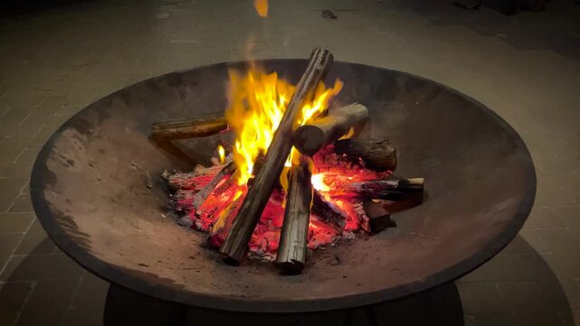brazier on the street with burning logs