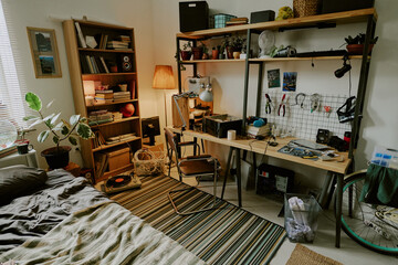High angle shot of technician workspace with tools in messy dorm bedroom