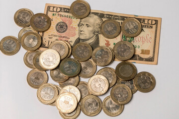 ten dollar bill and coins of one thousand Colombian pesos