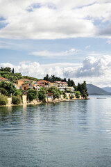 Fototapeta premium Cruise from Nidri port in Lefkada or Lefkas Greek island, Ionian Sea near Preveza. Summer vacation on boat, cloudy sky