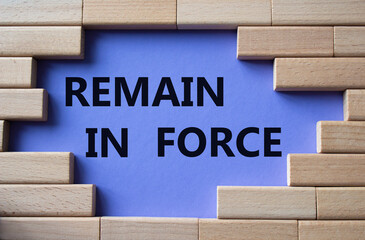 Remain in Force symbol. Concept words Remain in Force on wooden blocks. Beautiful purple background. Business and Remain in Force concept. Copy space