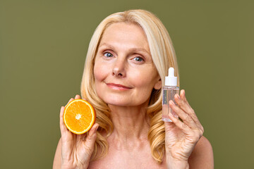 A Radiant Woman Applying Orange Skincare Serum That Promotes a Healthy and Vibrant Glow