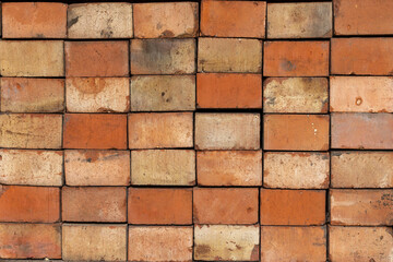 Obraz premium A pile of red bricks stacked in a masonry pattern