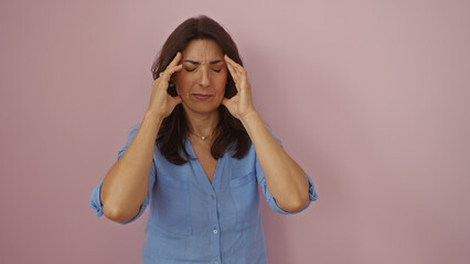 Woman suffering headache middleaged female hispanic isolated pink background mature person pain